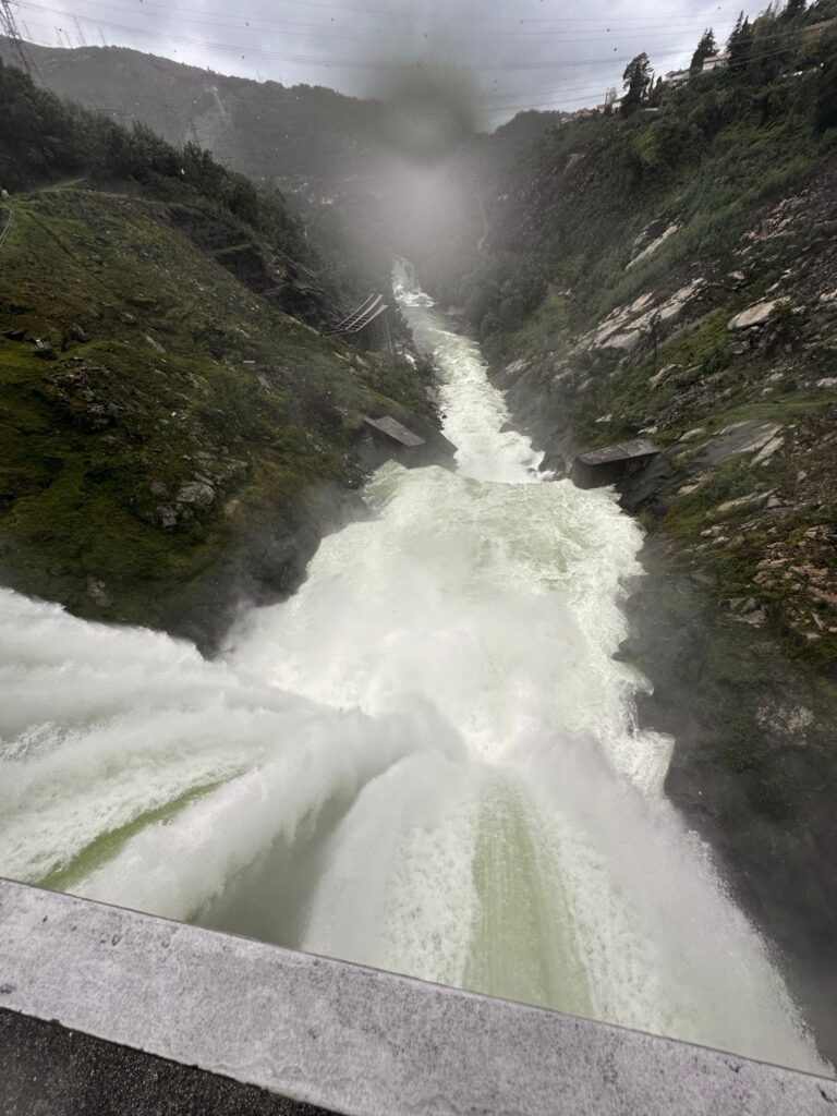 A waterfall rushing through a mountain gorge