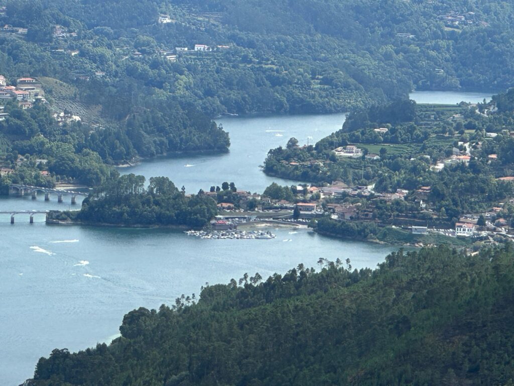 A river winding through green wooded valleys