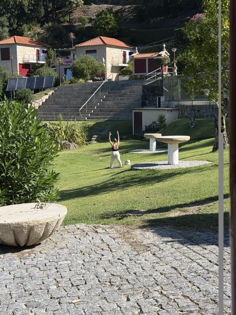 A woman practising Yoga on the lawn in the gardens